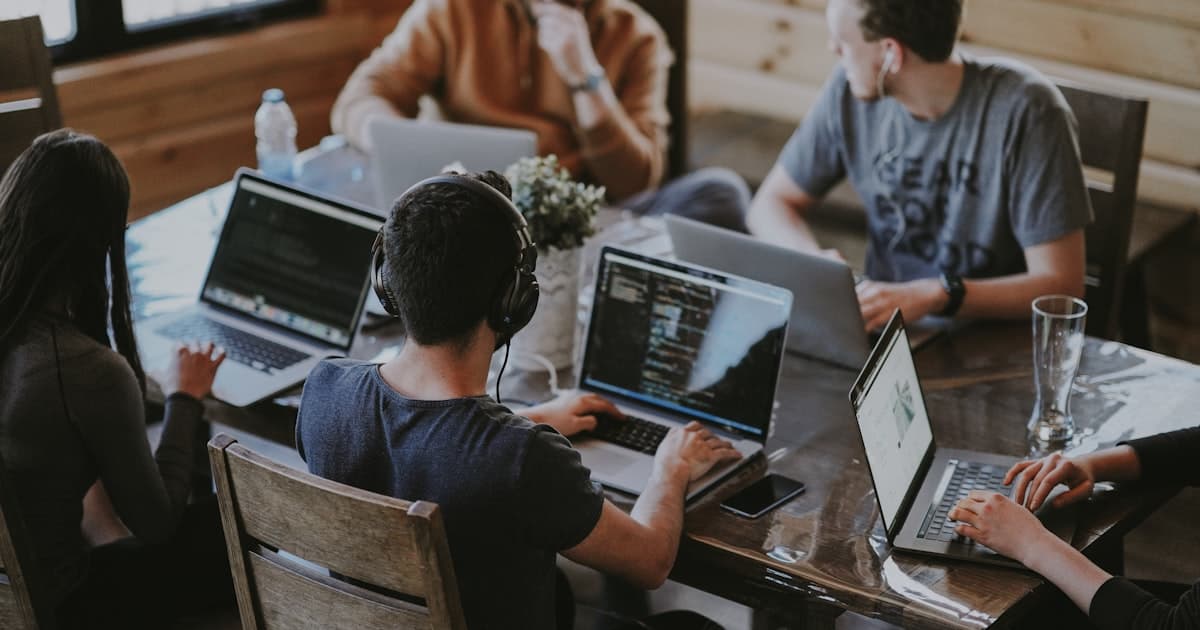 Small team collaborating around a table in a modern office.